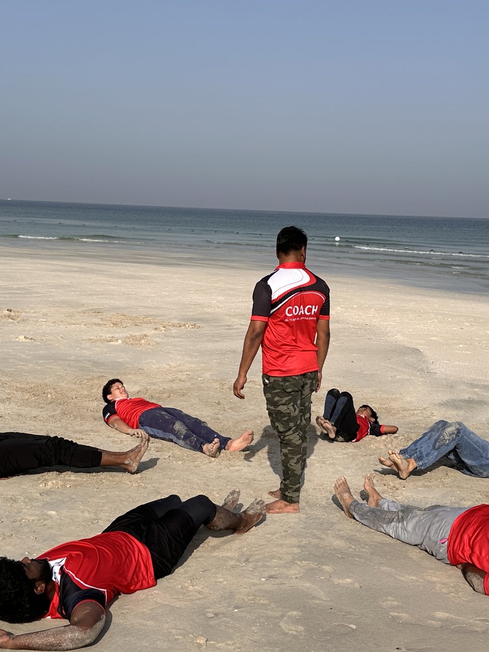 Team fitness training on the beach with Coach Musthafa